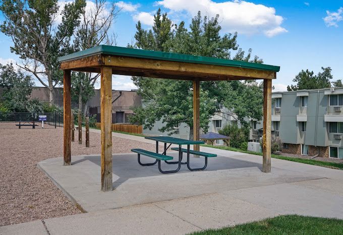 Photo showing a canopy area with a bench underneath