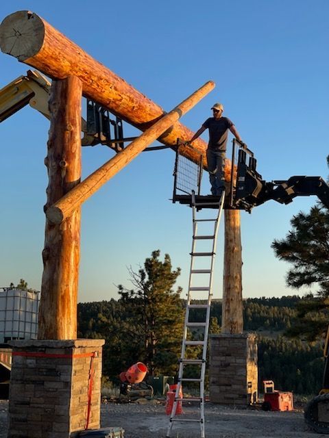 A man standing on top of a wooden structure with a ladder