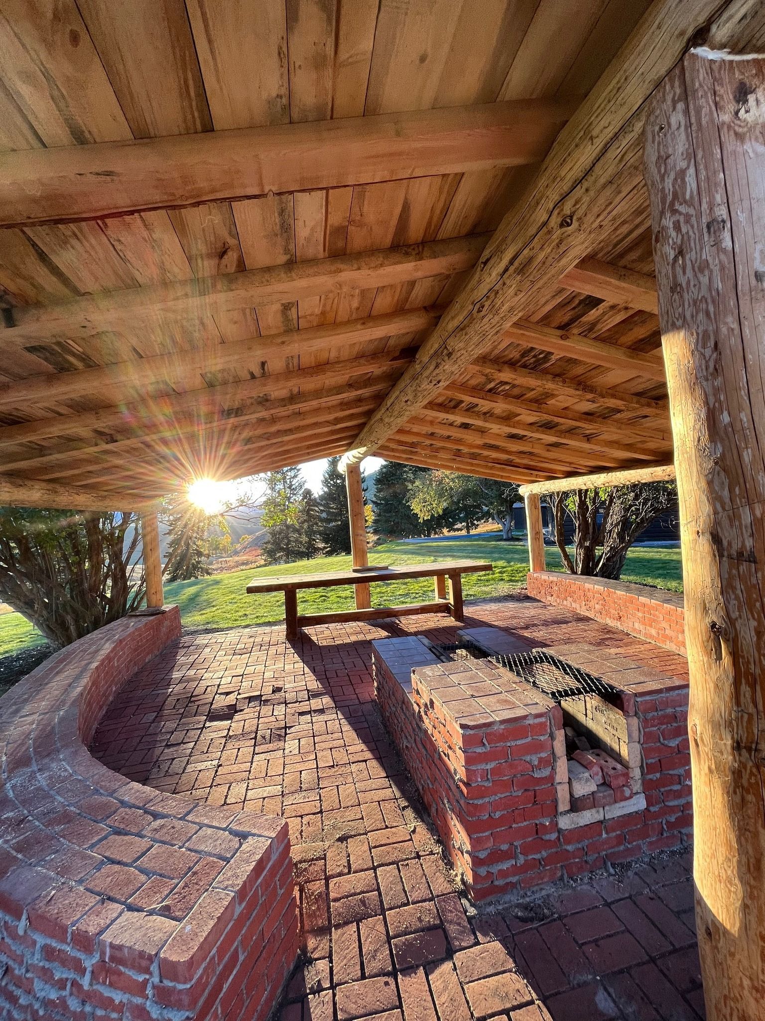 The sun is shining through the roof of a wooden structure.