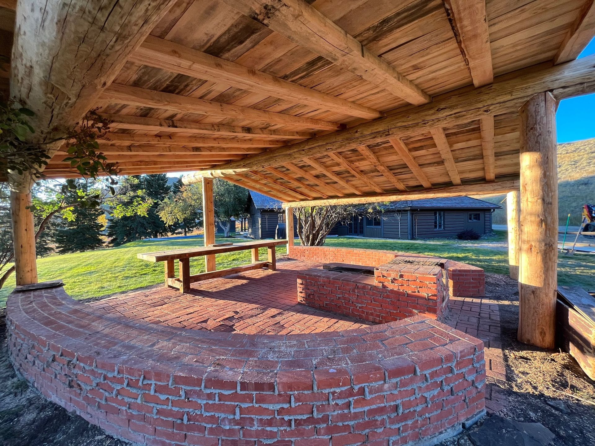 A wooden structure with a brick foundation and a wooden roof.