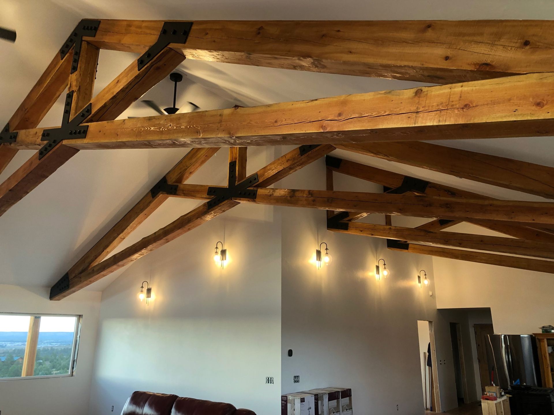 A living room with a vaulted ceiling and wooden beams