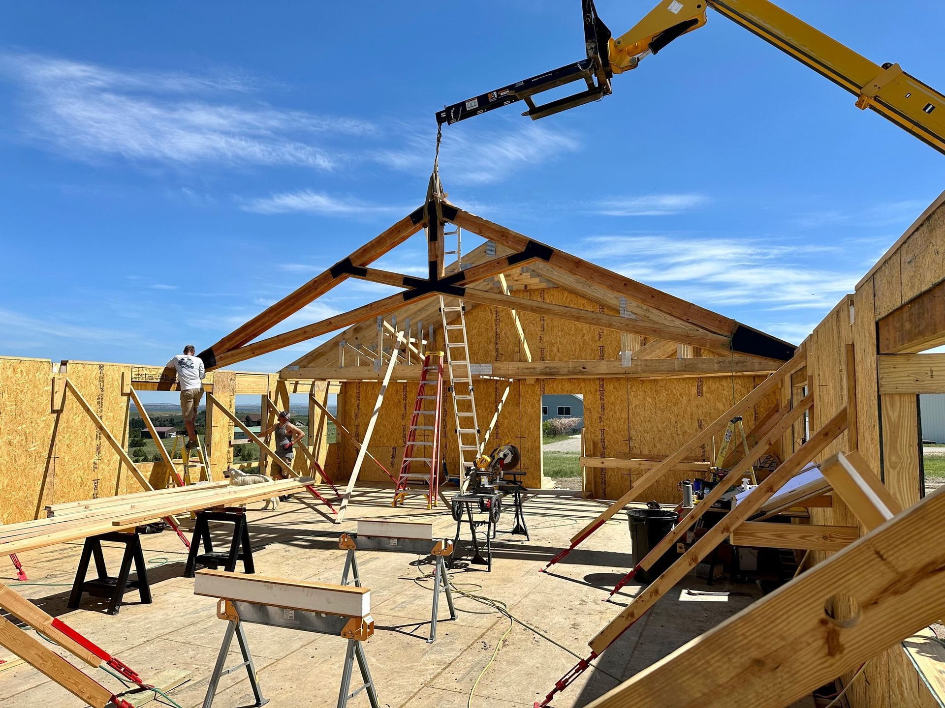 A large wooden structure is being built with a crane.
