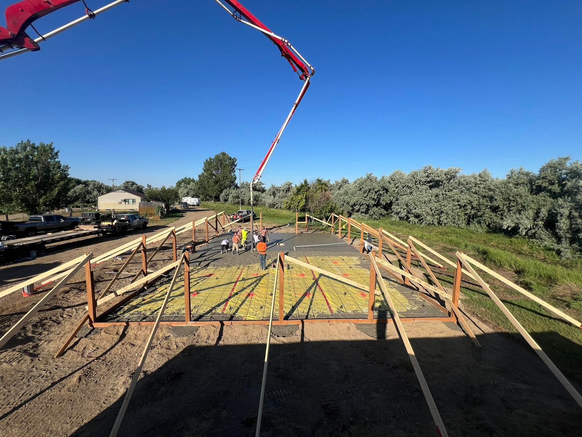 A concrete pump is being used to pour concrete on a construction site.