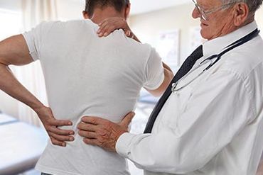 Accident — Doctor examining back of patient in Newburgh NY