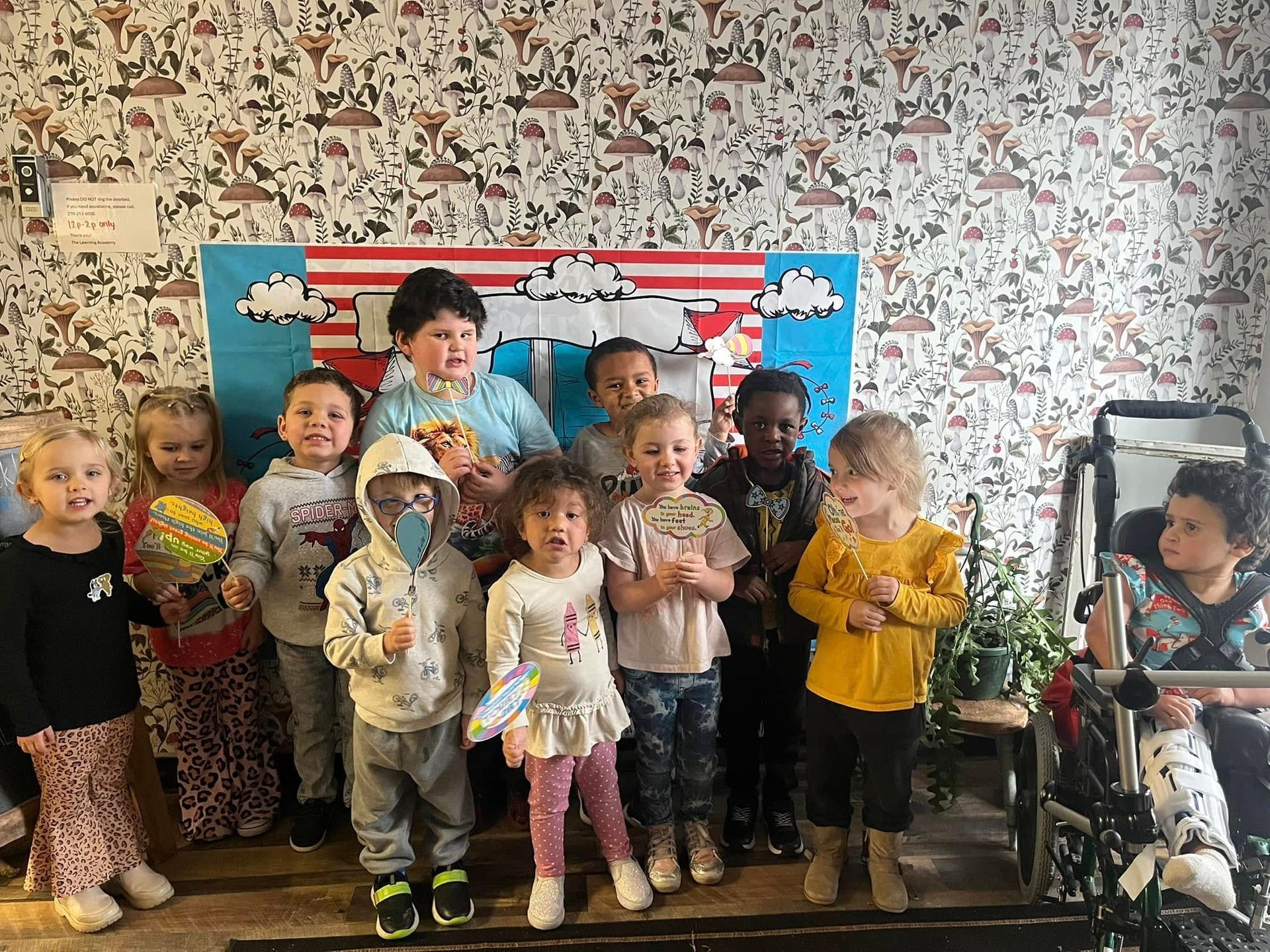 A group of children are posing for a picture in a room.