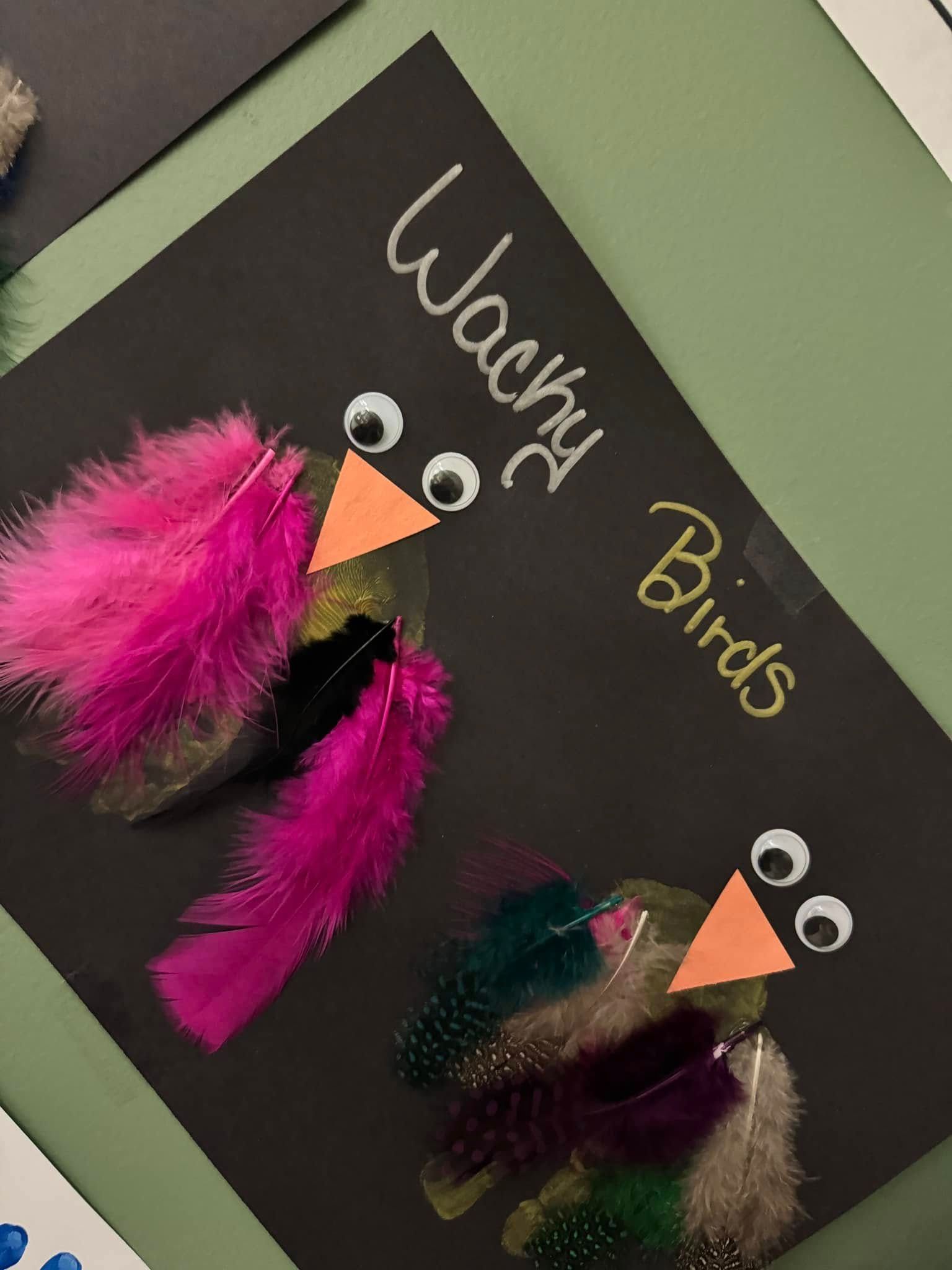 A black piece of paper with wacky birds written on it