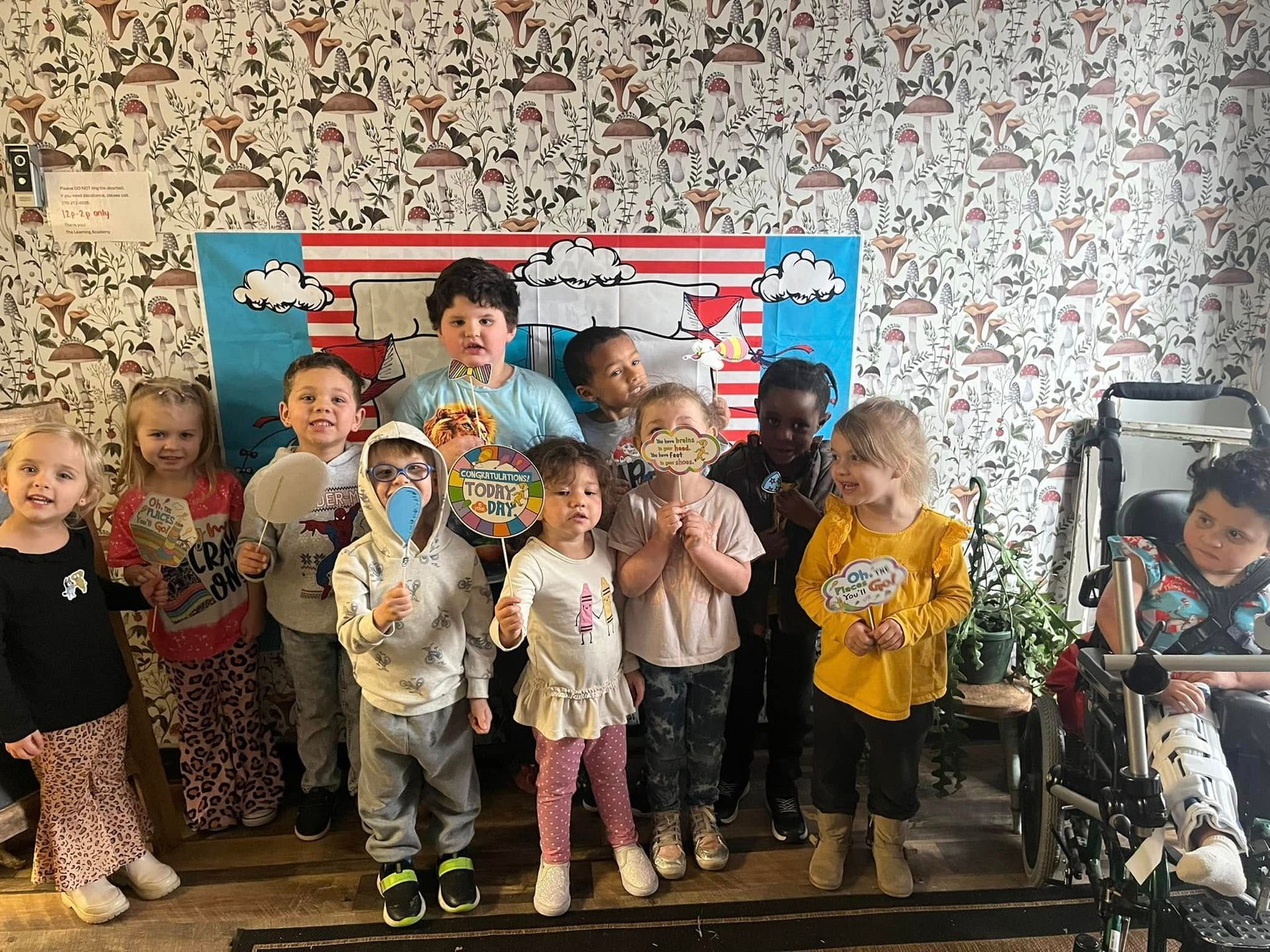 A group of children are posing for a picture in a room.