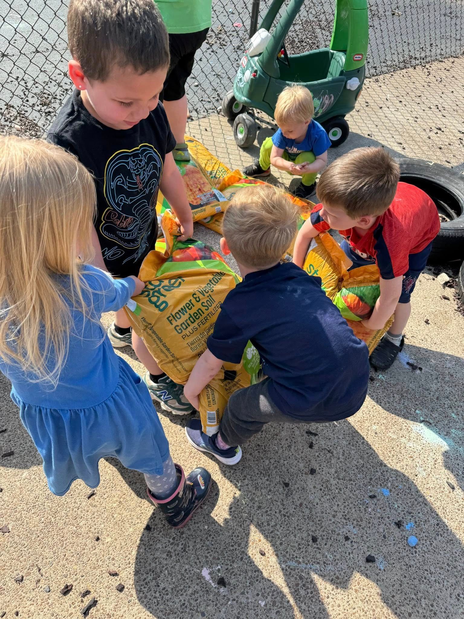 A group of children are playing with toys on the ground.