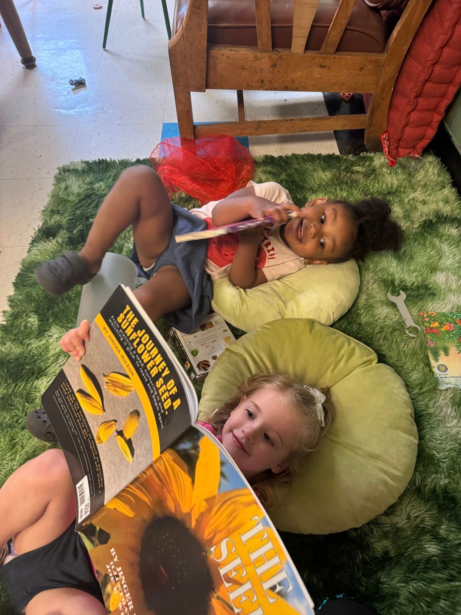 Two young girls reading