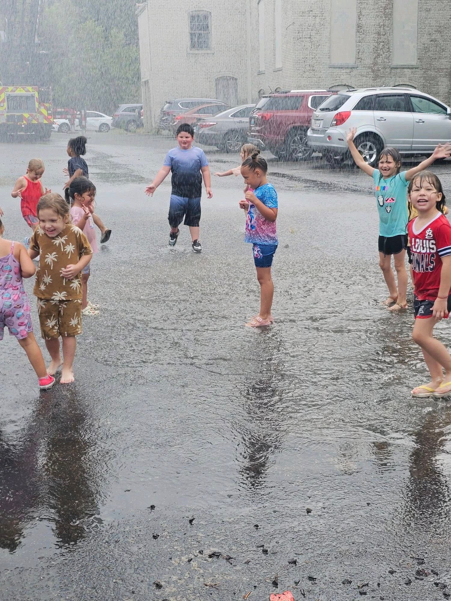 A group of children are playing in the rain.
