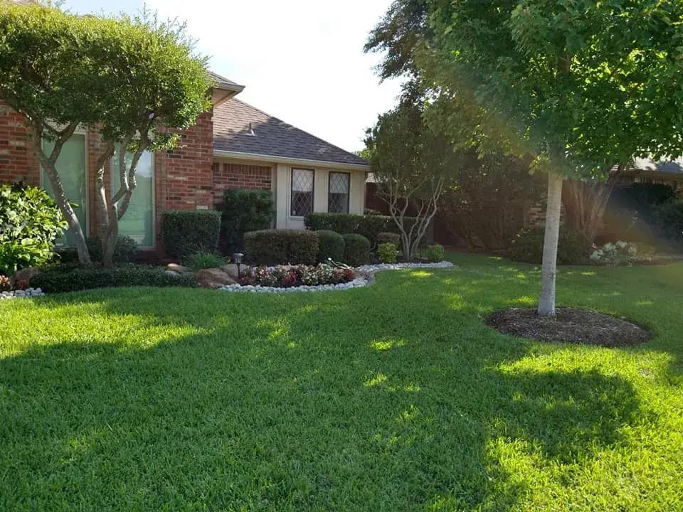 A Lush Green Lawn in Front of a Brick House