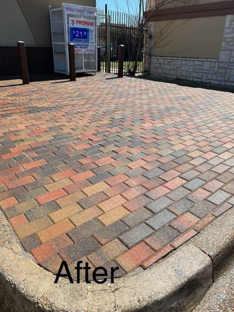 A picture of a brick driveway after being cleaned.