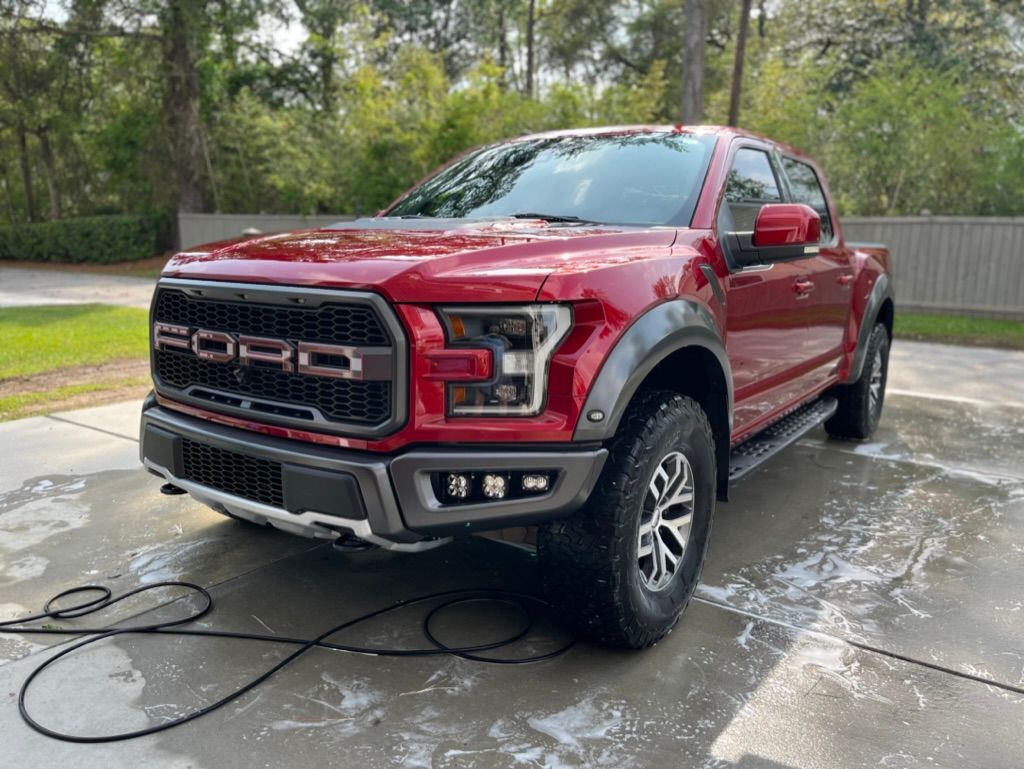 Image of a detailed red truck parked on a clean driveway