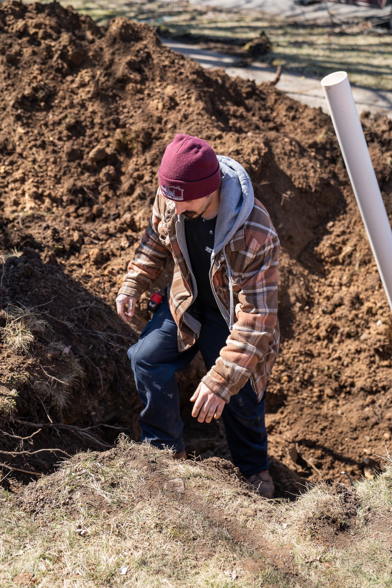 A man is digging a hole in the dirt.