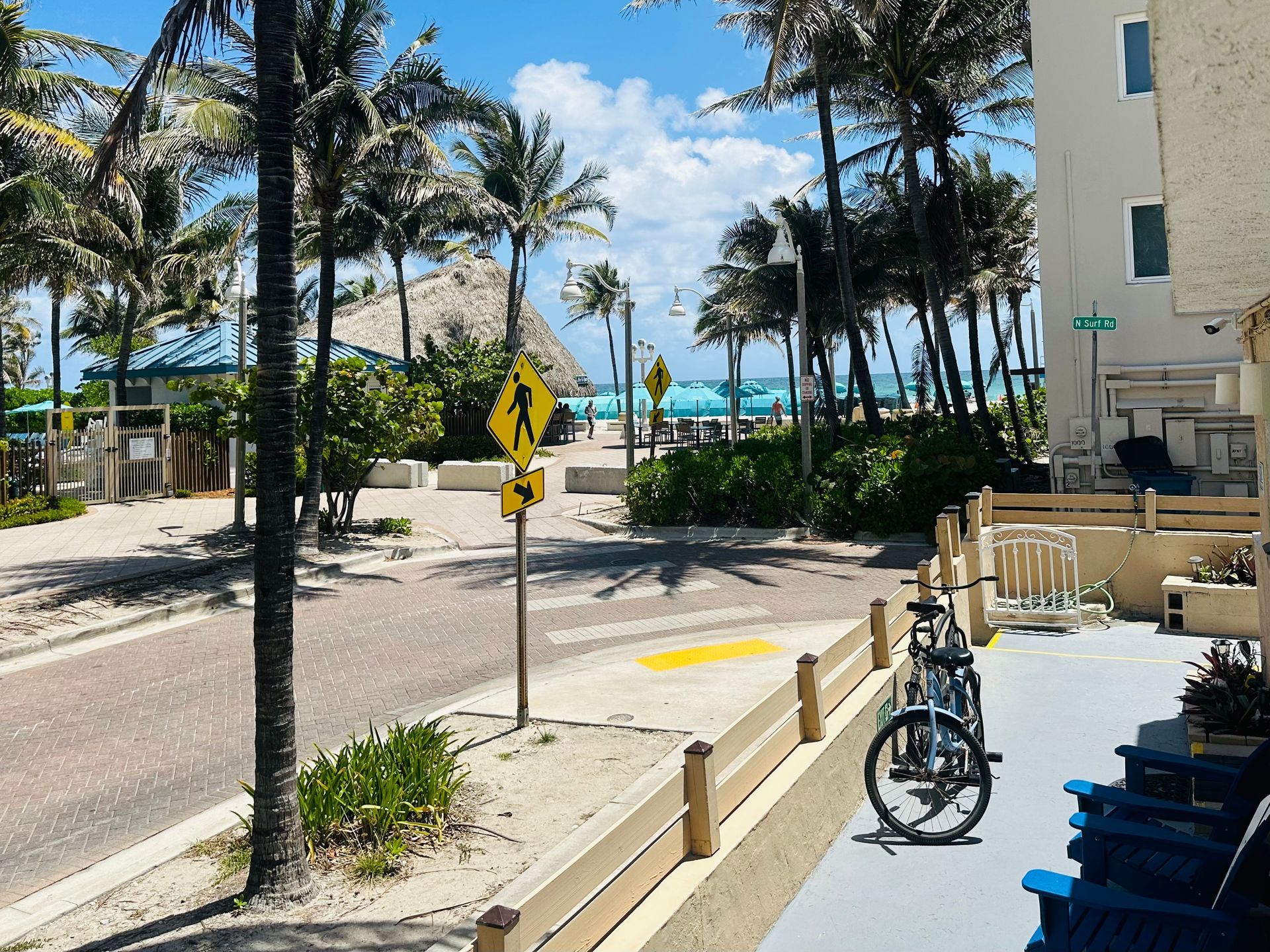 A balcony with chairs and bikes.