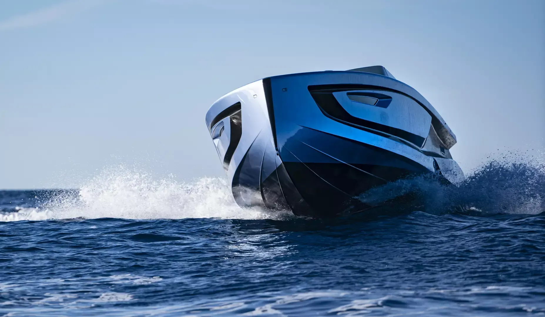 A blue and white boat is floating on top of a body of water.