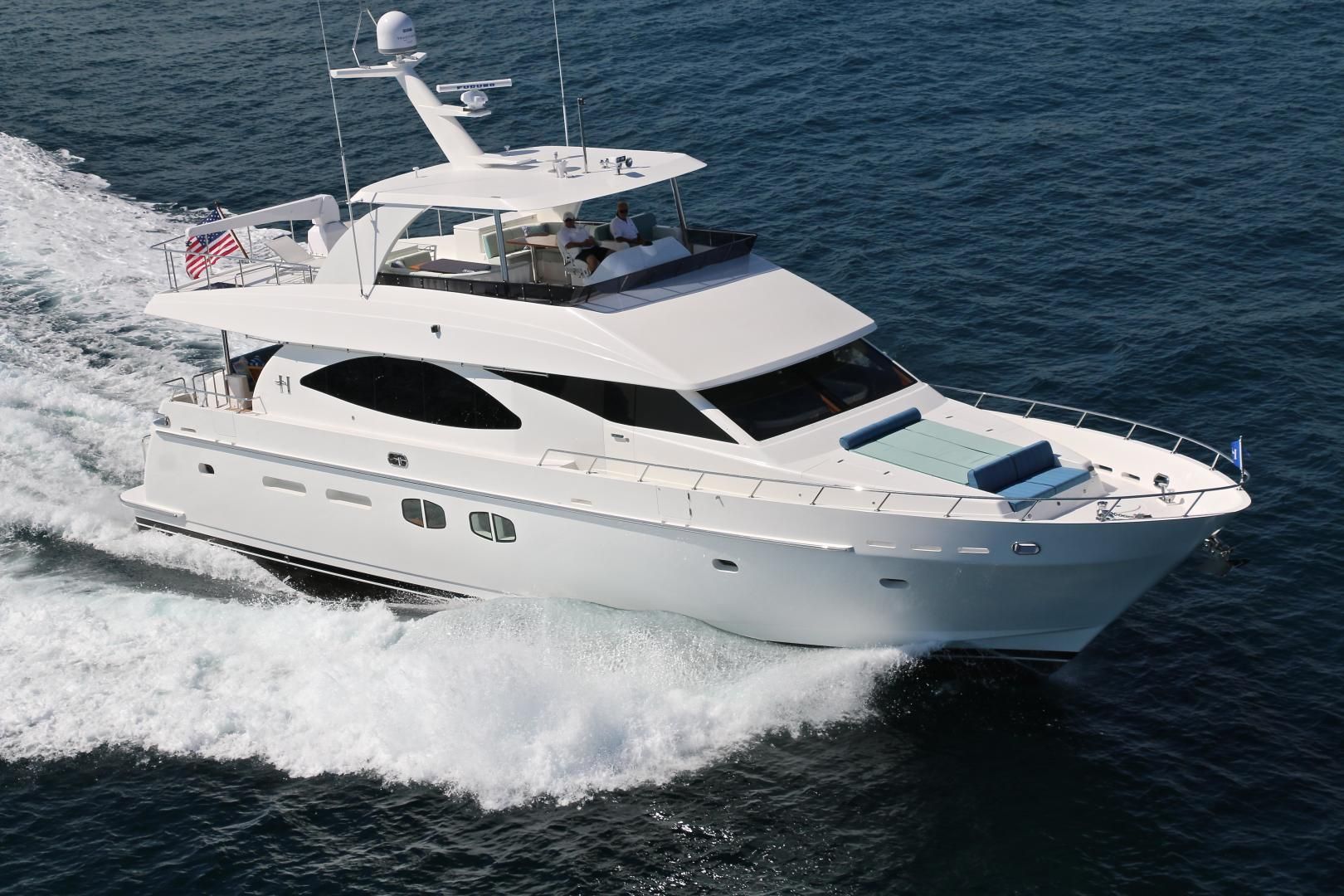 A large white yacht is floating on top of a body of water.