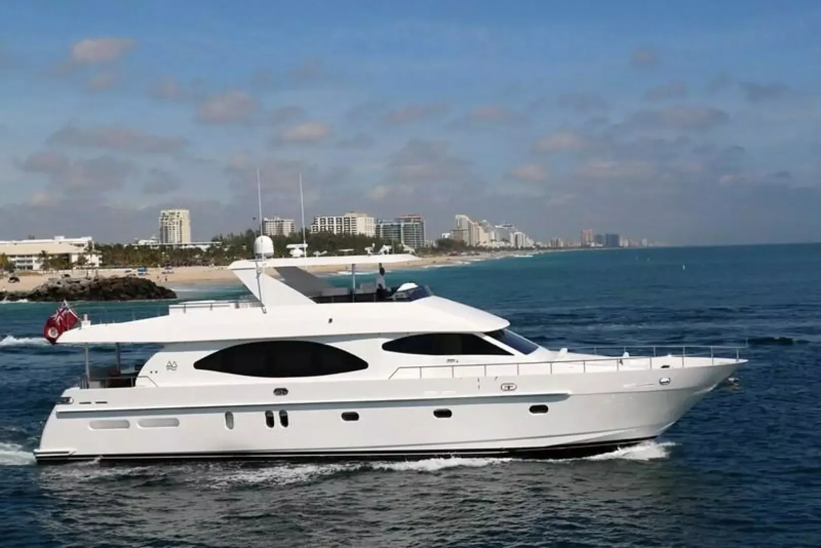 A large white yacht is floating on top of a body of water.