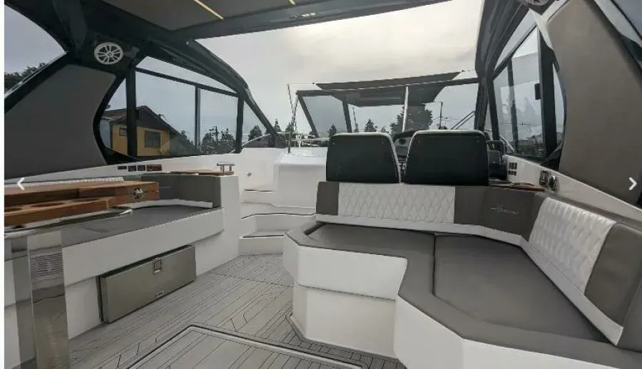 The inside of a boat with a lot of seats and a table.