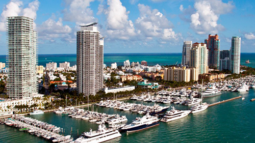 An aerial view of a city with lots of boats in the water