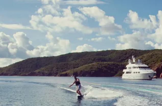 A large yacht is floating on top of a body of water.