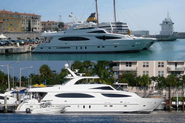 A large blue and white yacht is floating on top of a body of water.