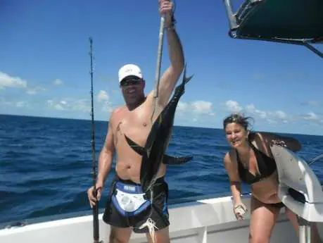 A large white yacht is floating on top of a body of water.