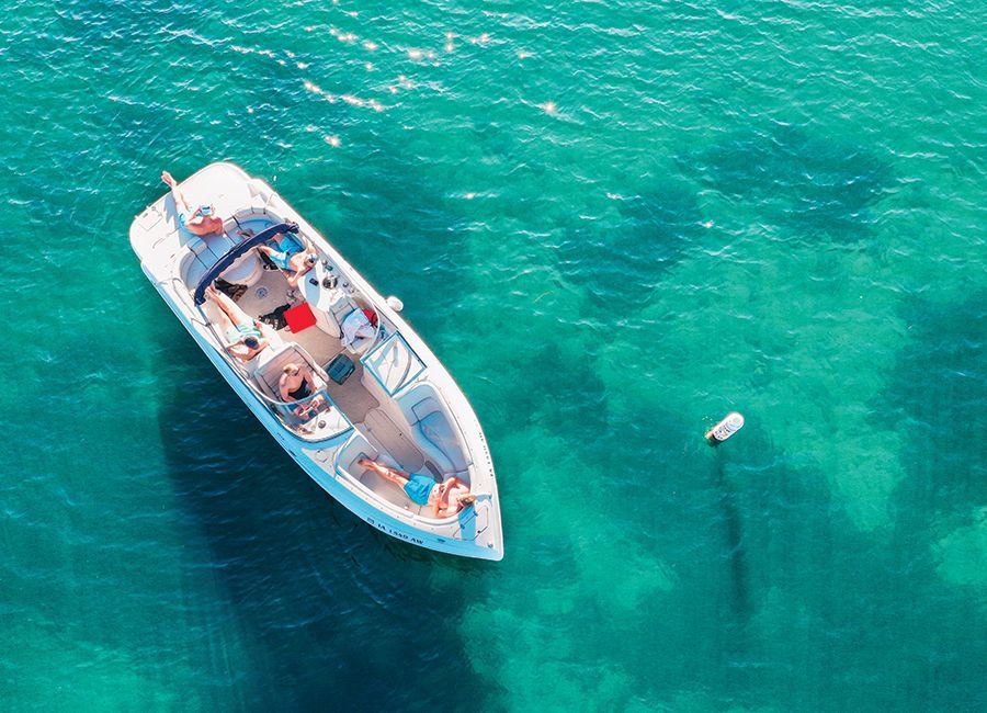 An aerial view of a boat floating on top of a body of water.