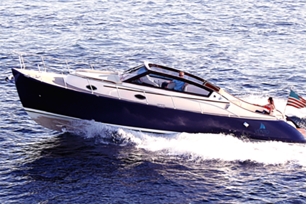 A blue and white boat is floating on top of a body of water