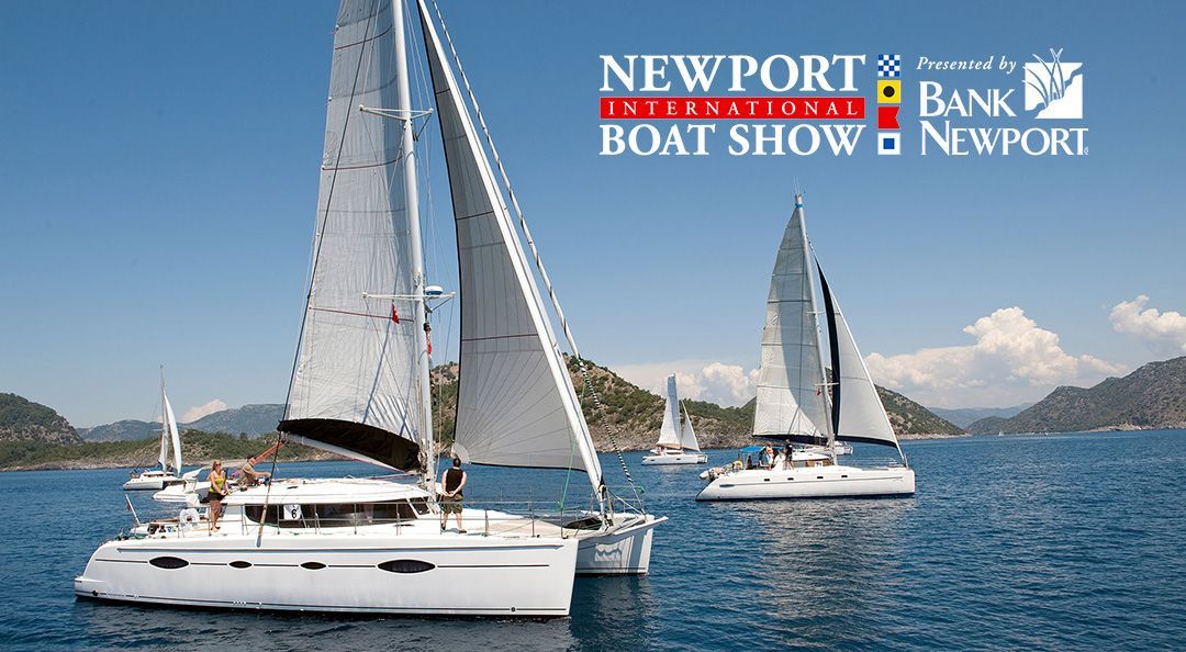 A group of sailboats are floating on top of a body of water.