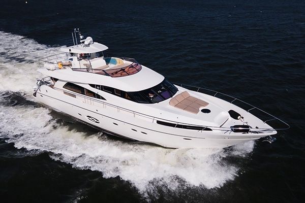 A large white yacht is floating on top of a body of water.