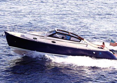 A blue and white boat is floating on top of a body of water.