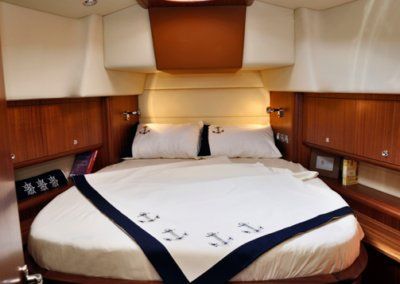 A bedroom with a round bed and a blanket that says zzz