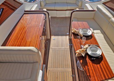 A boat with a wooden table and plates on it