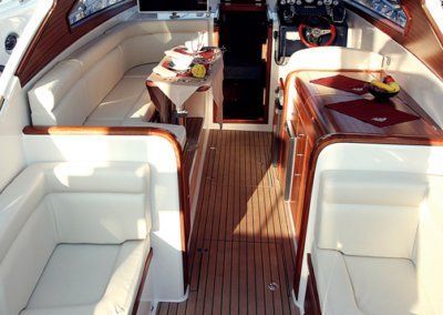 The inside of a boat with a table and chairs