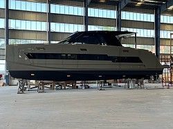 A large boat is sitting in a warehouse.