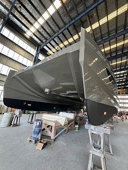 A boat is being built in a warehouse.