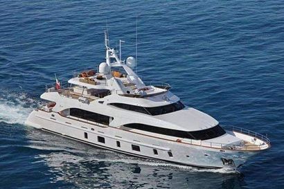 A large white yacht is floating on top of a body of water.