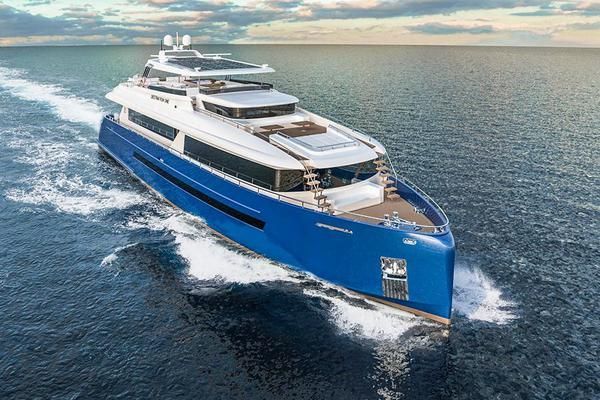 A large blue and white yacht is floating on top of a body of water.