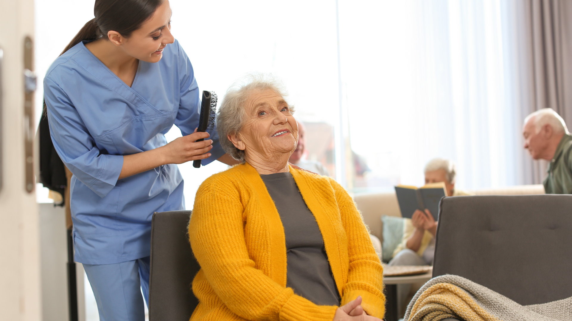 A nurse is brushing the hair of an elderly woman in a nursing home.