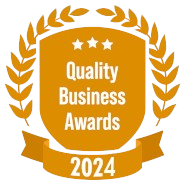A shield with a laurel wreath and a ribbon that says quality business awards 2024.