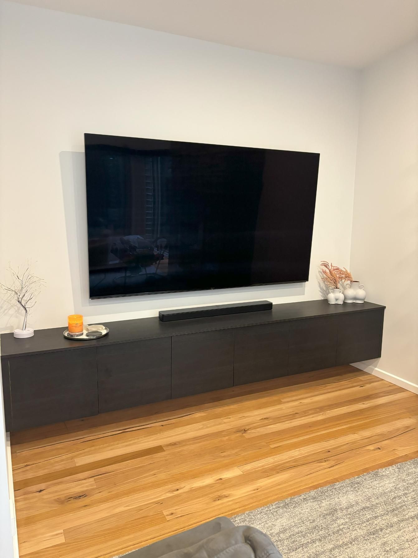 A living room with a TV on the wall above a cabinet — Darko's Kitchens in Barrack Heights, NSW