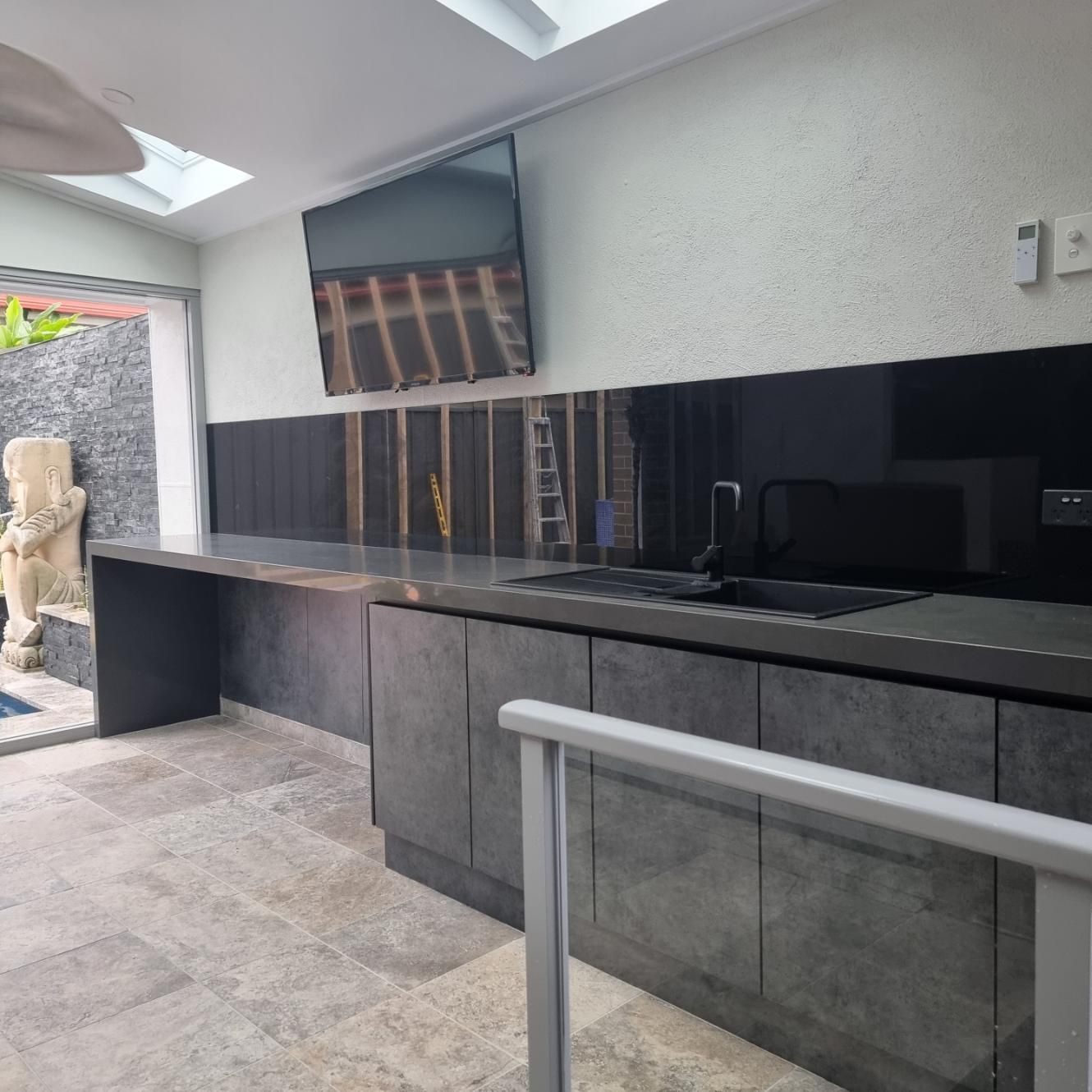 A Kitchen with A Large Flat Screen Tv on The Wall Above the Sink — Darko's Kitchens in Barrack Heights, NSW