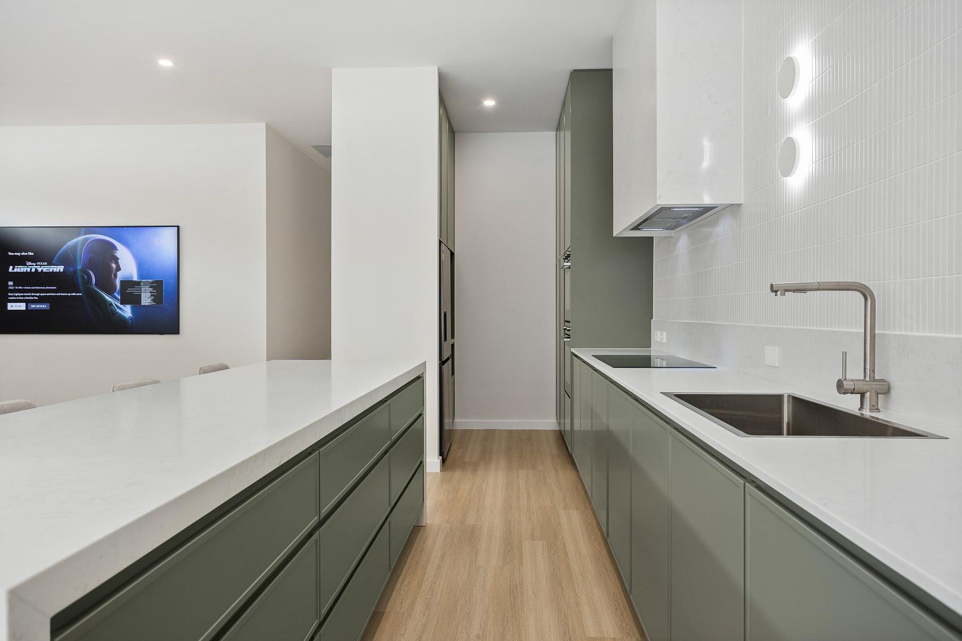 A Kitchen with A Sink , Stove , and Television on The Wall — Darko's Kitchens in Horsely, NSW