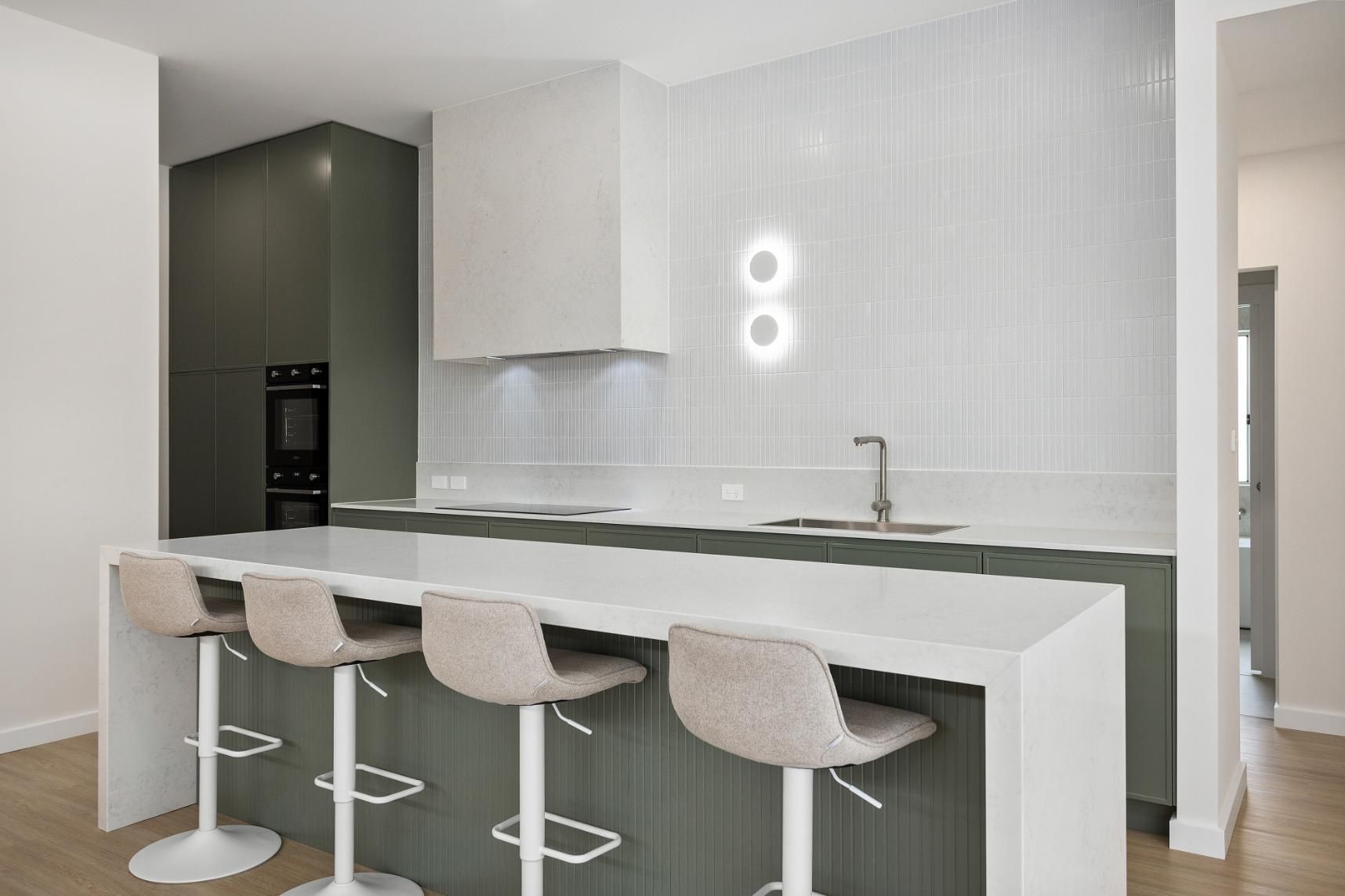 A Kitchen with A Long Island and Stools — Darko's Kitchens in Horsely, NSW