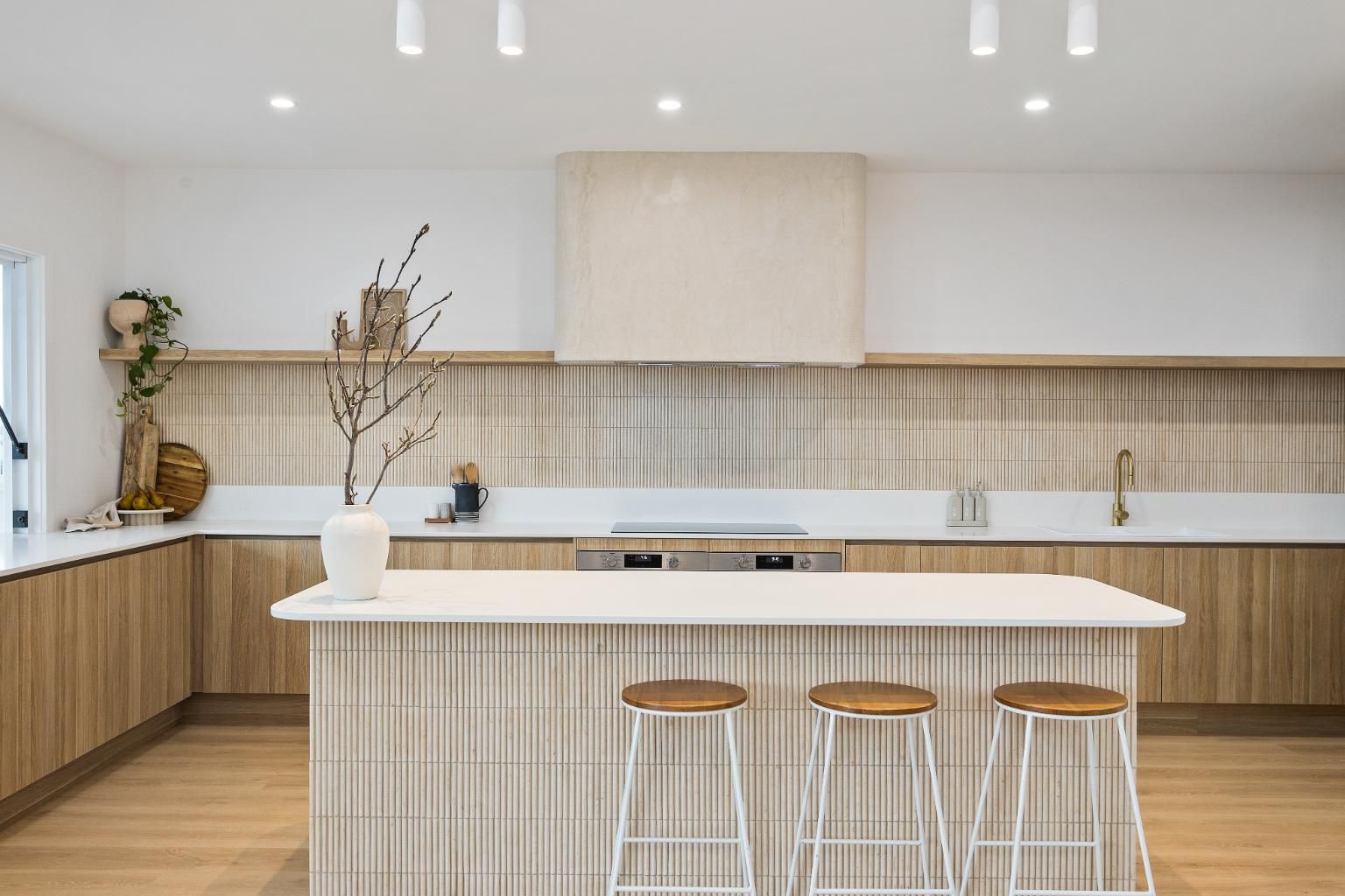 A Kitchen with A Large Island and Stools — Darko's Kitchens in Calderwood, NSW