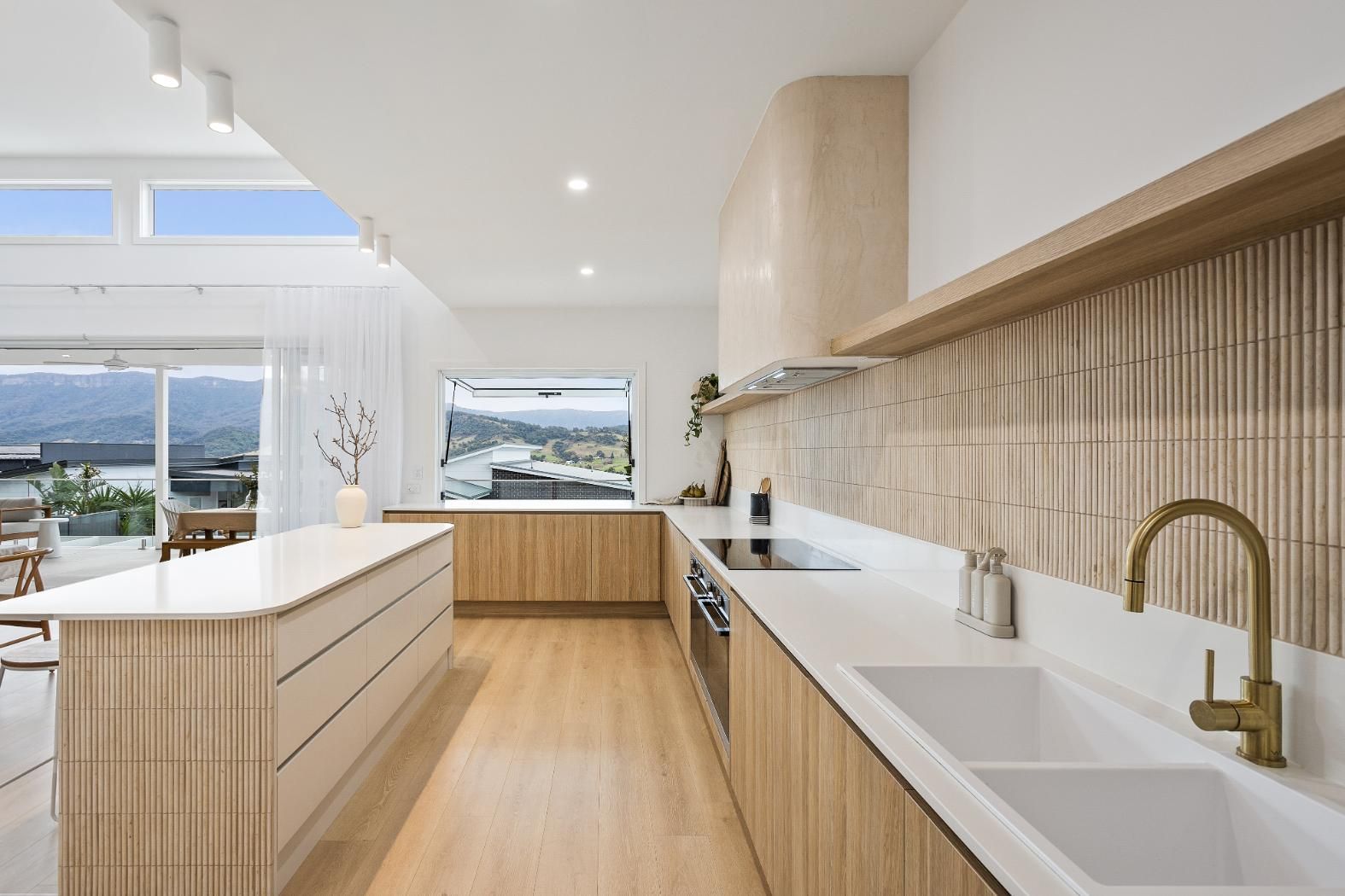 A Kitchen with Wooden Cabinets, White Counter Tops, a Sink and A Stove — Darko's Kitchens in Calderwood, NSW