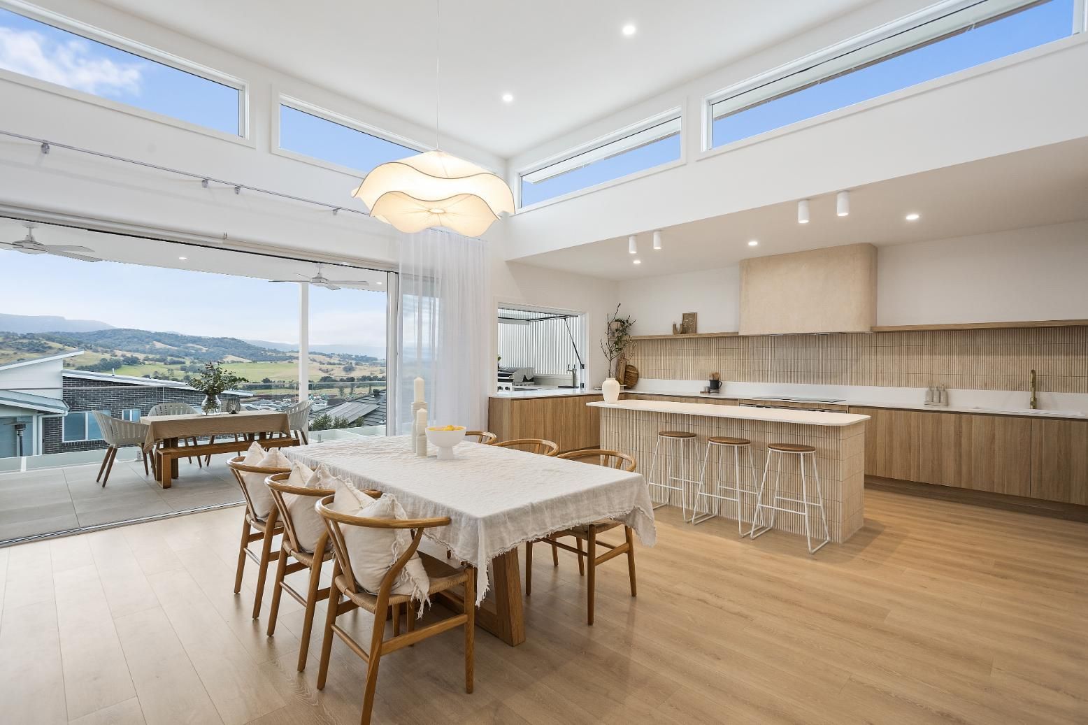 There Is a Dining Table and Chairs in The Middle of The Room — Darko's Kitchens in Calderwood, NSW