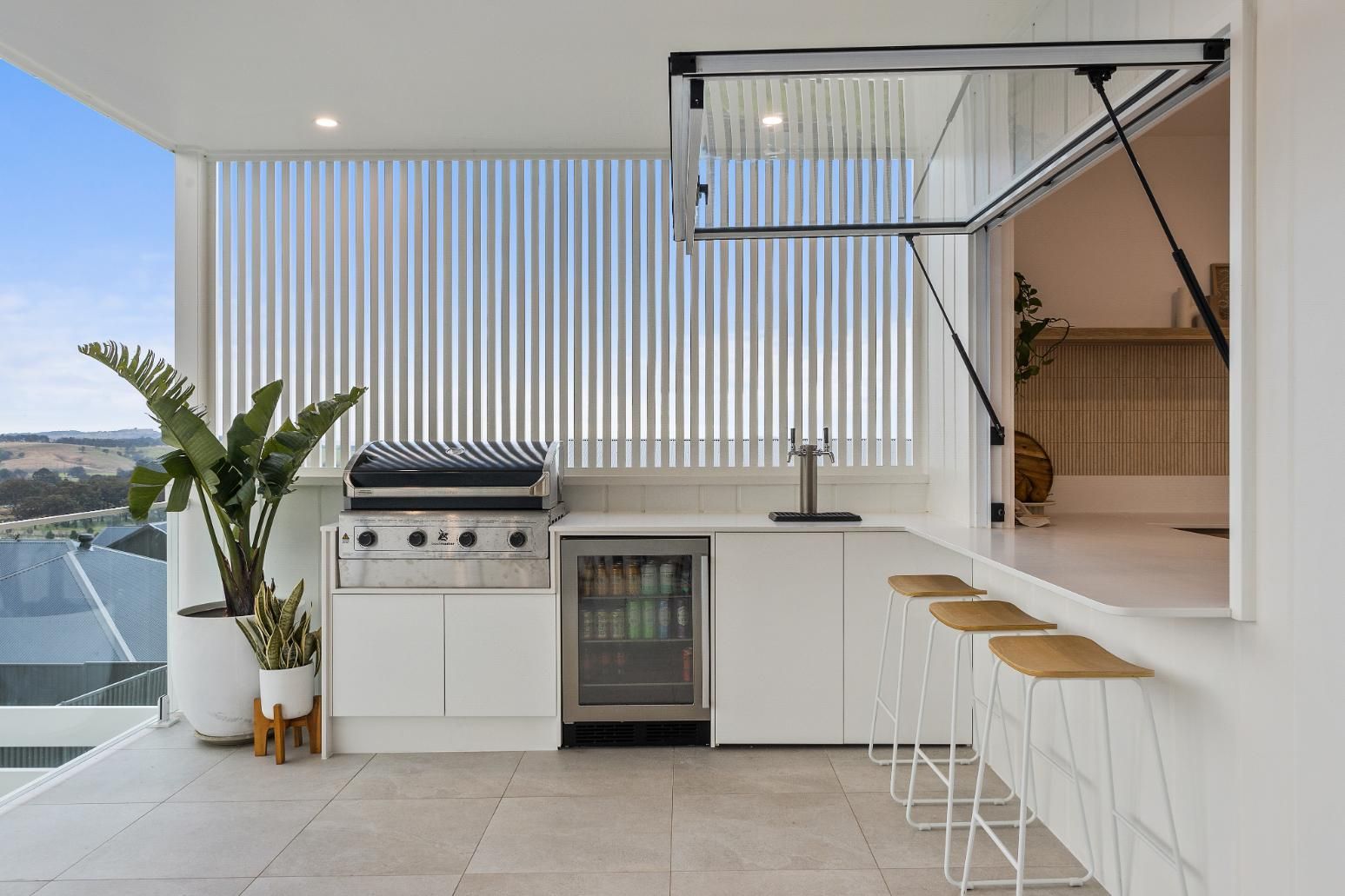 A Kitchen with A Grill, Refrigerator, and Stools — Darko's Kitchens in Calderwood, NSW
