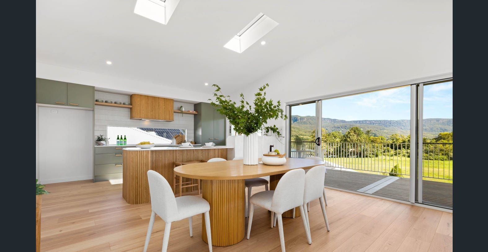 A Dining Room with A Table and Chairs and A Large Window — Darko's Kitchens in Calderwood, NSW